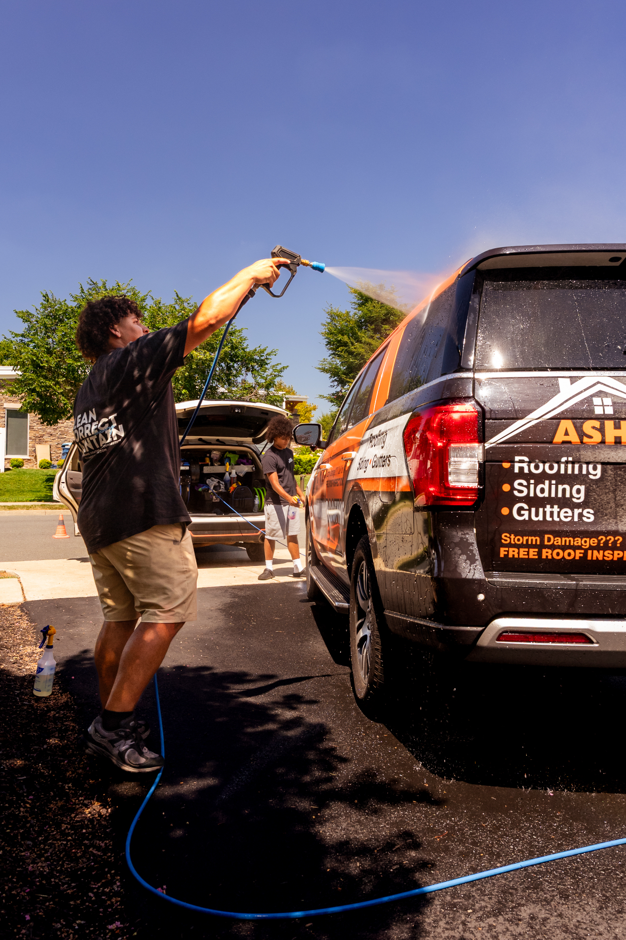 Slums Mobile Detailing team washing a vehicle on location