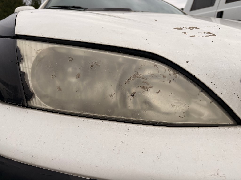 Same headlight foggy and oxidized before restoration