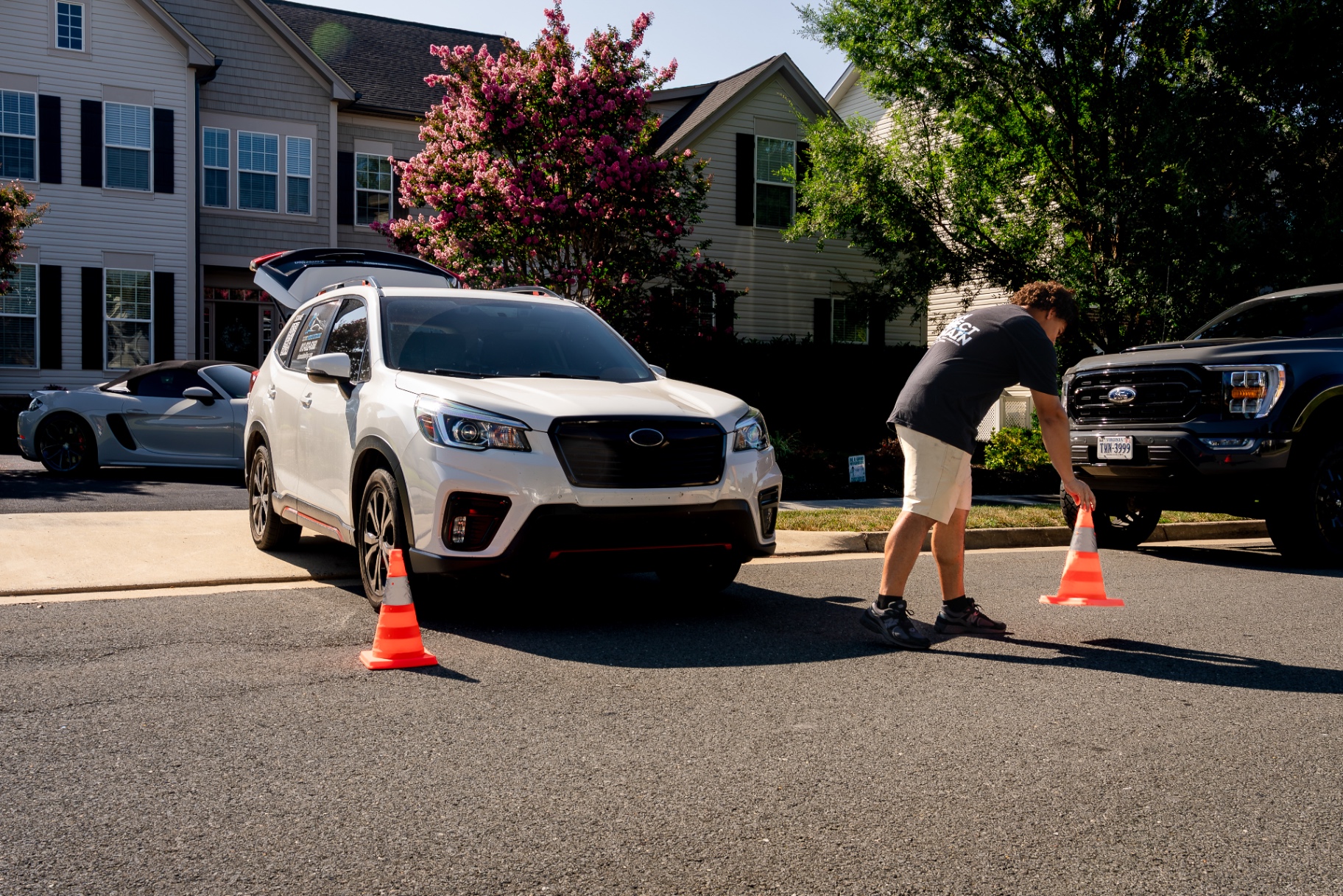 Dominick setting out safety cones around a customer's SUV before a mobile detail in Hagerstown, MD