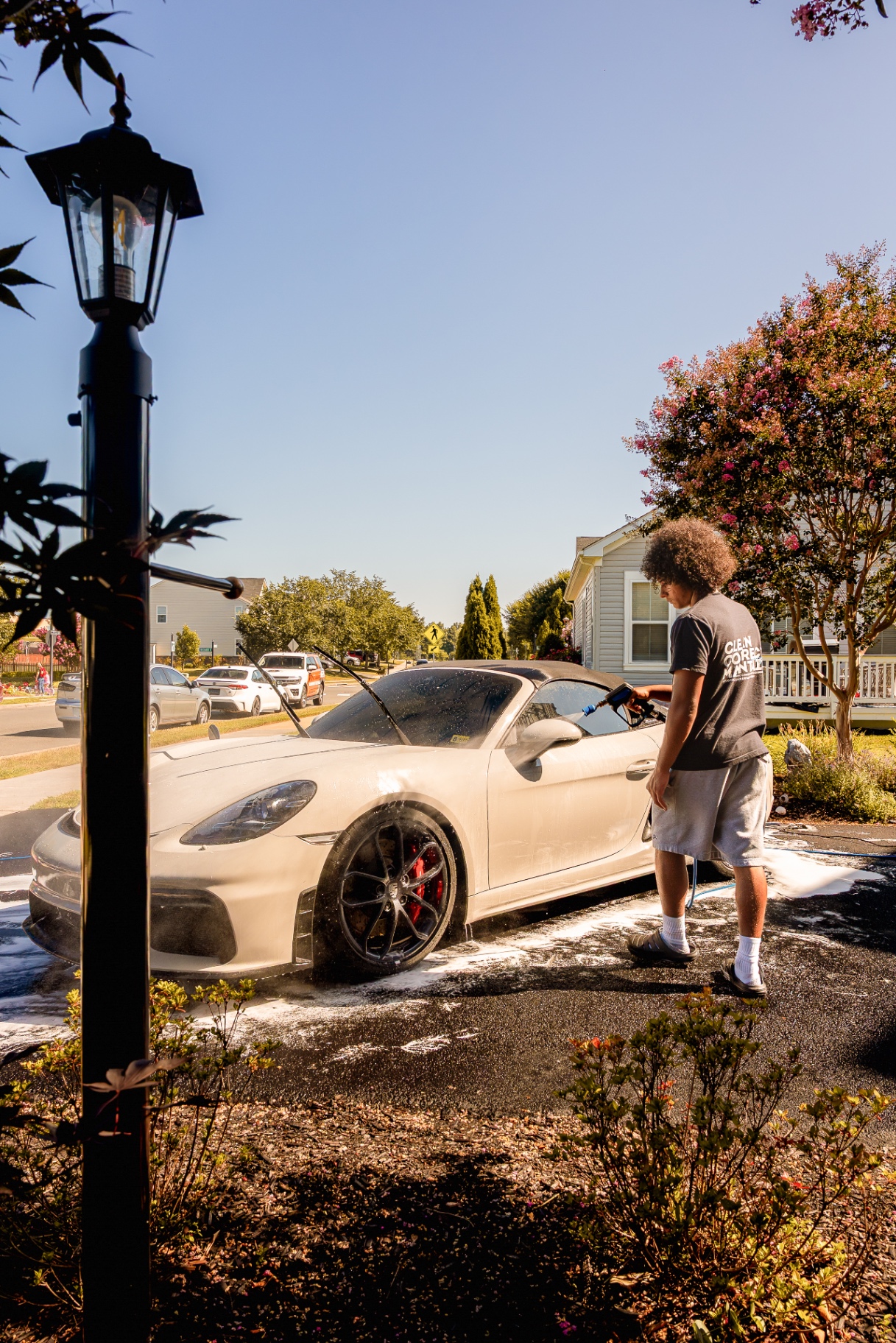 Foam bath on a Porsche Boxster during a mobile exterior detail on a residential driveway