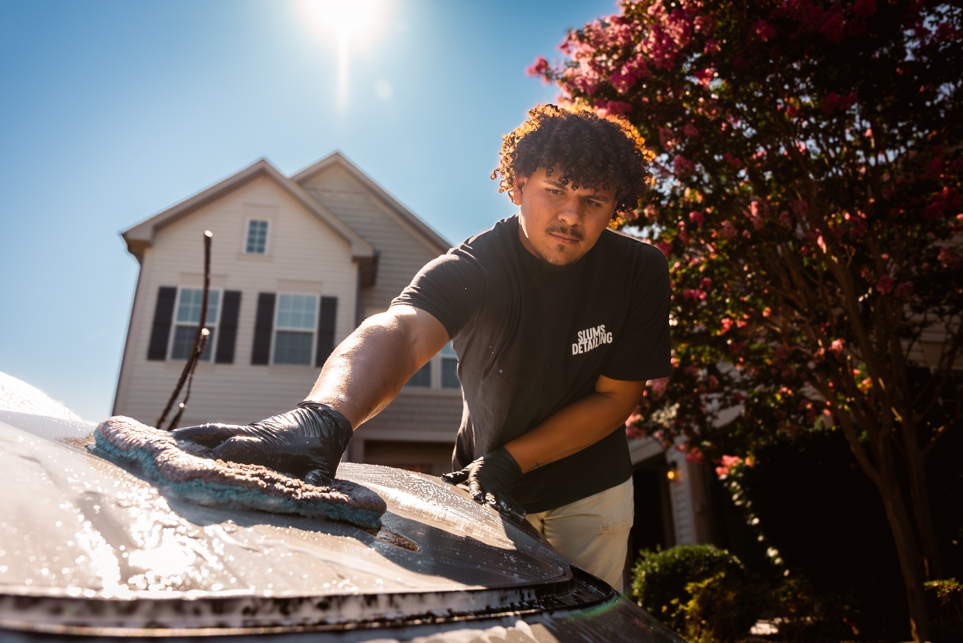 Dominick hand-washing a car hood during a mobile detailing job in Martinsburg, WV